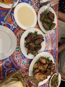 Different plates of food on the table. Chicken and lamb