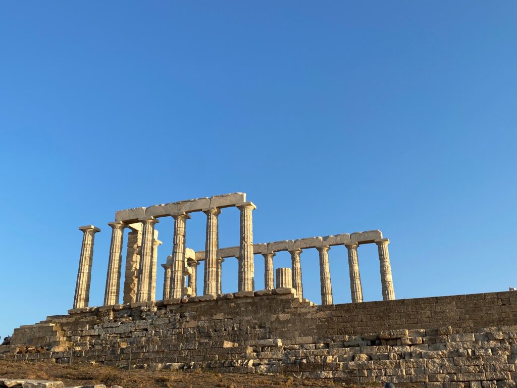 Side view of poseidon's temple from the bottom (the temple is old stone columns almost in a rectangle shape though not all is there)