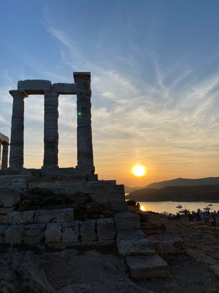 temple of poseidon (old stone columns) with the sunset in the background