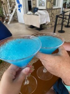 2 bright blue frozen drinks in a martini glass