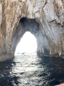 natural arch rock formation on the water. Big enough to boat through it.