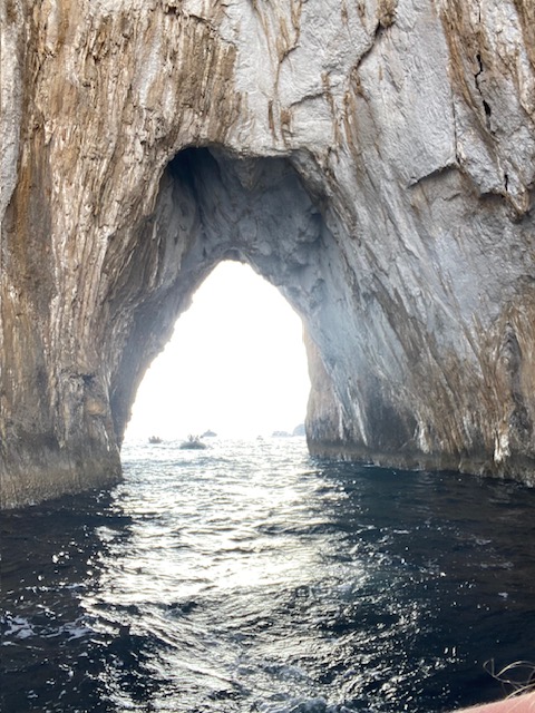 natural arch rock formation on the water. Big enough to boat through it. 