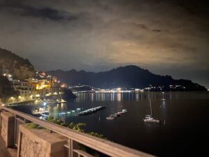 Atrani from a distance at night. It is lit up and very pretty. Can also see the hills/mountain in the background